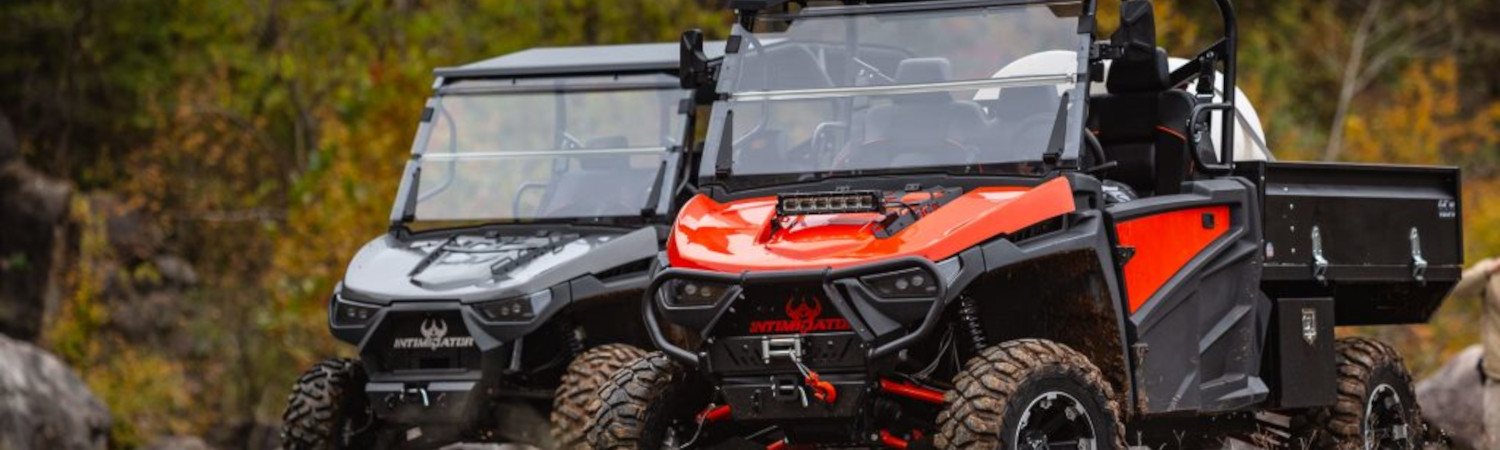 Two 2022 Intimidator UTVs parked in a forest